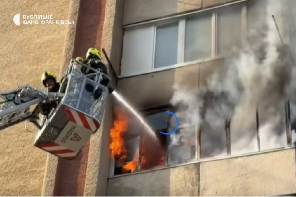 Firefighters in a crane basket work to extinguish a fire in a residential high-rise following a drone strike. (Source: Suspilne Ivano-Frankivsk)