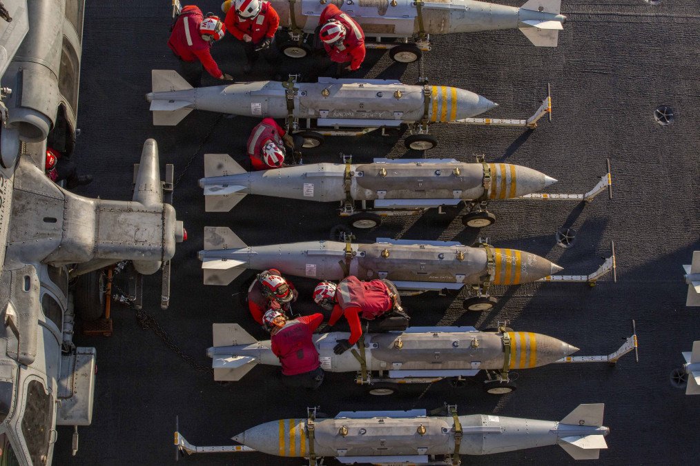 US Sailors prepare to stage ordnance on the flight deck of Nimitz-class aircraft carrier USS Abraham Lincoln (CVN 72) in support of Operation Epic Fury on February 28, 2026, at Sea. (Source: Getty Images)