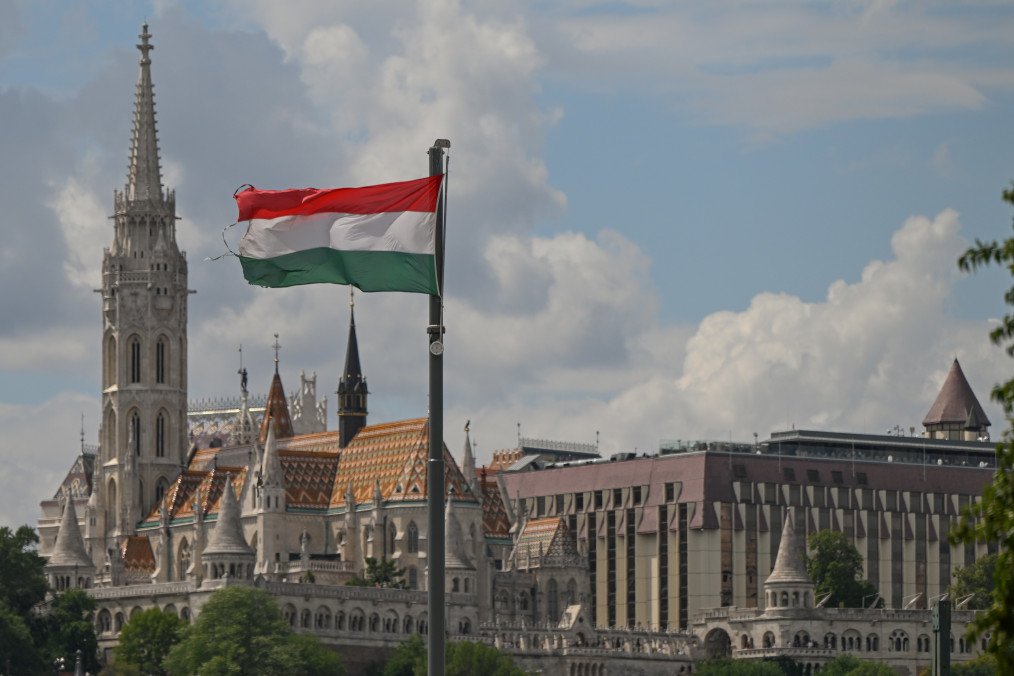 The national flag of Hungary waves from a pole with the historic Matthias Church and Fisherman's Bastion complex rising in the background. (Source: Getty Images)