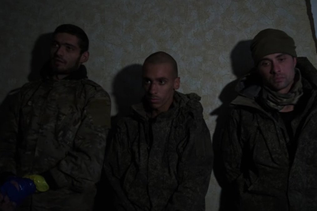 Captured Russian soldiers stand against a wall after surrendering to Ukrainian forces during a drone-assisted operation in the Kharkiv region. (Source: 127th Separate Mechanized Brigade)
