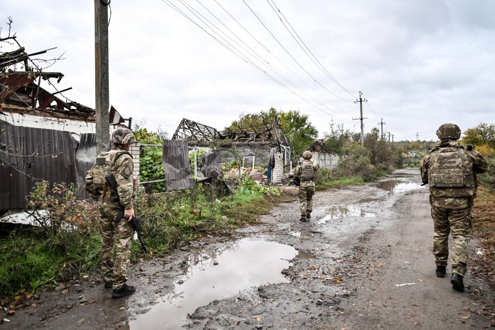 Illustrative image. Armed Zaporizhzhia police officers walk along a street during a humanitarian mission to evacuate a family from the front-line settlement of Komyshuvakha, Zaporizhzhia region, Ukraine, on October 19, 2026.