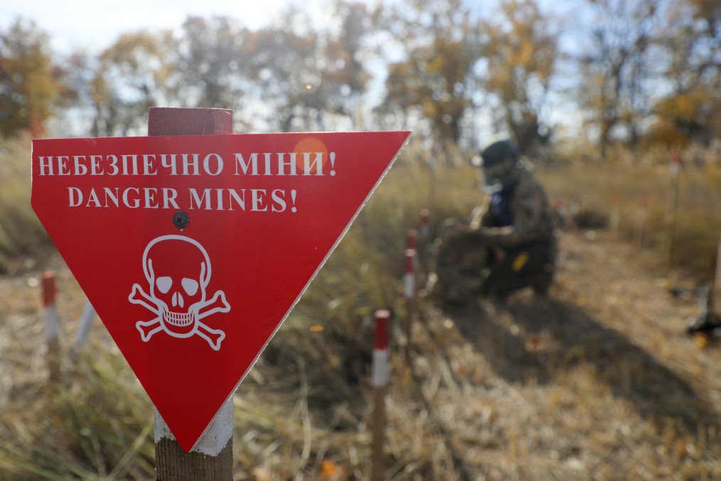 Ukrainian war veterans take part in humanitarian demining training near a “Danger, Mines” warning sign in Kyiv, Ukraine, on October 30, 2025. (Source: Getty Images) Ukrainian war veterans take part in humanitarian demining training near a “Danger, Mines” warning sign in Kyiv, Ukraine, on October 30, 2025. (Source: Getty Images)