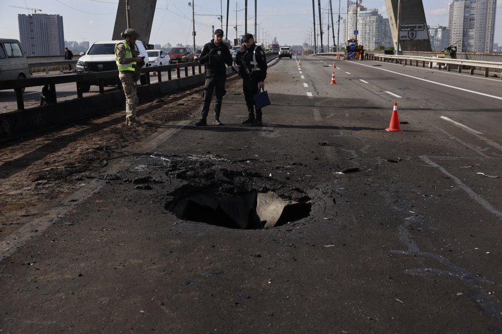 Police officers look at the damages following a Russian drone strike on the Northern Bridge in Kyiv on October 4, 2026. (Source: Getty Images)