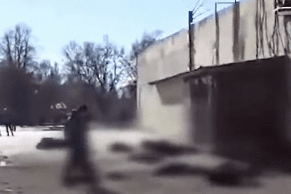A blurry scene showing a group of people in front of a building in Chernihiv, Ukraine in 2022. (Source: Office of the Prosecutor General)