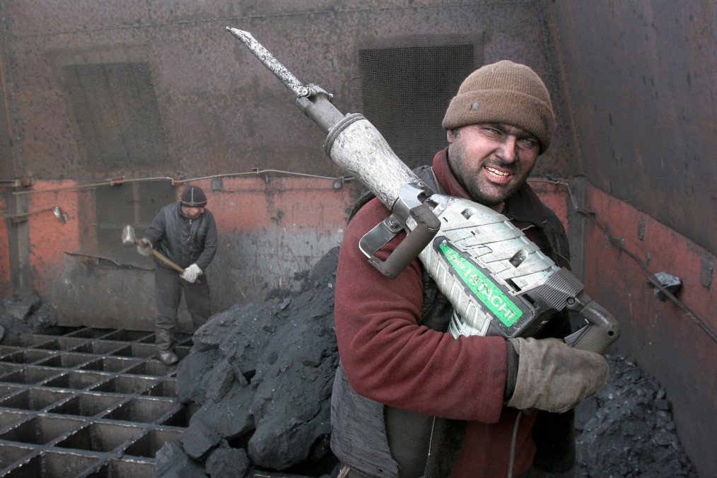 A workman holds a jackhammer for breaking apart coal at an open mine in the Siberian town of Shestaki on February 4, 2009. (Source: Getty Images)
