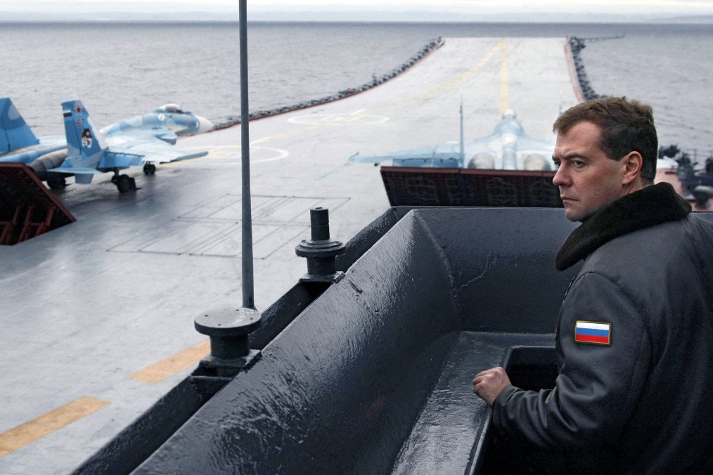 Dmitry Medvedev stands on the flight deck of the aircraft carrier Admiral Kuznetsov during the “Stability 2008” military exercises in the Barents Sea, October 11, 2008. (Source: Getty Images)