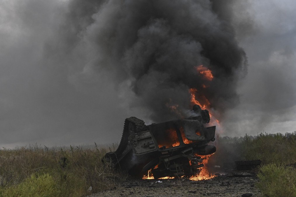 A destroyed Russian MT-LB armored vehicle burns in a field near Izium, Kharkiv region. (Source: Getty Images)