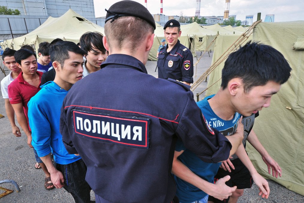Detained immigrants gather at a temporary camp in the Moscow.