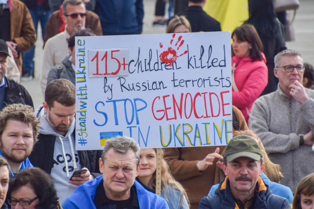International Court of Justice Grants Russia’s Counterclaim in Genocide Case With Ukraine A protester holds a “Stop genocide in Ukraine” placard during the demonstration in Trafalgar Square in London, UK on March 20, 2023. (Source: Getty Images)