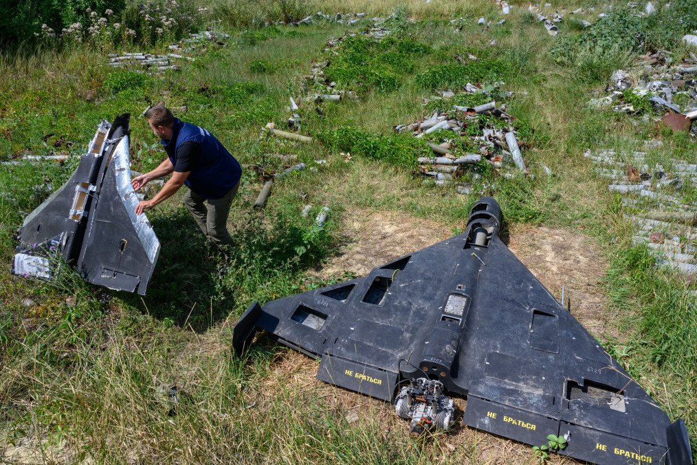 Dmytro Chubenko of the Kharkiv regional prosecutor’s office holds the remains of a Russian-made Gerbera drone, beside an Iranian-designed Shahed-136 drone, known as a Geran-2 in Russia. (Source: Getty Images)