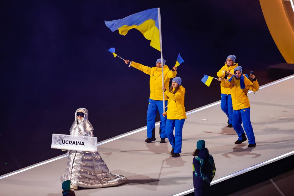 How a Russian National Ended Up Carrying Ukraine’s Sign at the Winter Olympic Games Ceremony Russian national Anastasia Kucherova leads Ukrainian team in the athletes' parade during the opening ceremony of the Milano Cortina 2026 Winter Olympics at San Siro Stadium on February 6, 2026 in Milan, Italy. (Photo: Getty Images)