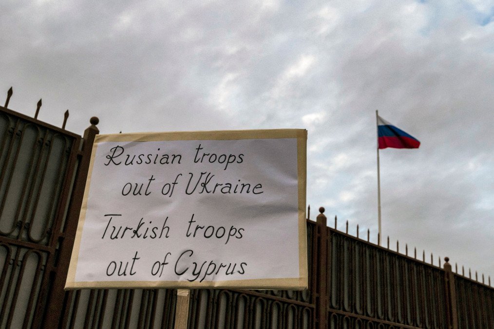 A sign is lifted as Ukrainians and Cypriots take part in a protest against Russia’s invasion of Ukraine, outside the Russian embassy in the Cypriot capital Nicosia on March 1, 2022. (Source: Getty Images)