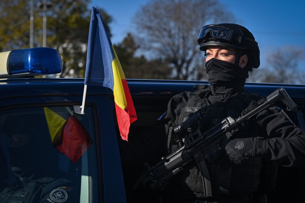 A female member of the Romanian Intelligence Service (SRI) takes part in a military parade on the National Day of Romania in Bucharest on December 1, 2021. A female member of the Romanian Intelligence Service (SRI) takes part in a military parade on the National Day of Romania in Bucharest on December 1, 2021.