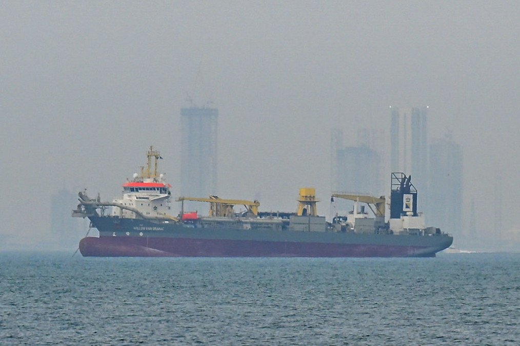 A commercial ship is viewed anchored off the coast of the United Arab Emirates, in the Strait of Hormuz, Dubai on March 2, 2026. (source: Getty Images)