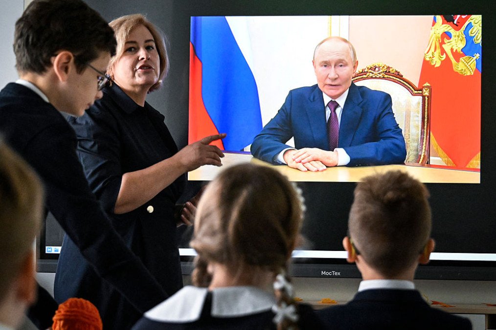 Pupils of a secondary school listen to Russia’s leader Vladimir Putin’s address at the first day of the new school year in Moscow on September 1, 2025. (Source: Getty Images)