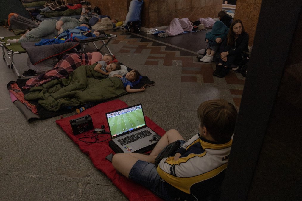 Kyiv Metro Shelters Record 52,500 People During Massive Russian Missile and Drone Attack A person watches on a laptop the FIFA World Cup 2026 Round of 32 match between Belgium and Senegal as people take shelter at a metro station during Russian air attacks on Kyiv, early on July 2, 2026. (Source: Getty Images)