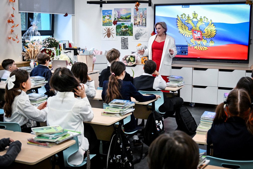 Russian Teachers Instructed to Identify Disloyal Students During Weekly Patriotic Classes Pupils of a secondary school listen to a teacher addressing at the first day of the new school year in Moscow on September 1, 2026. (Source: Getty Images)
