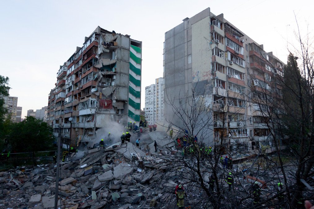 Rescuers work near damaged residential buildings following a large-scale Russian drone and missile attack on Kyiv, Ukraine, May 14, 2026. (Source: Getty Images)