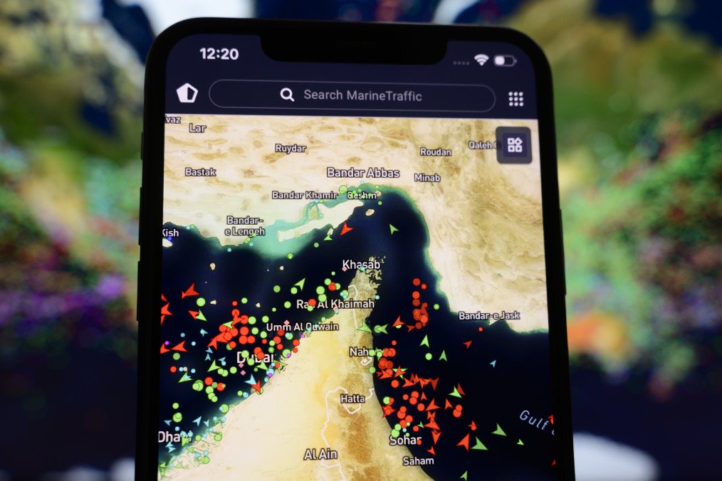 A smartphone displaying the MarineTraffic app shows dense vessel traffic in the Strait of Hormuz amid rising regional tensions, March 27, 2026. (Source: Getty Images)