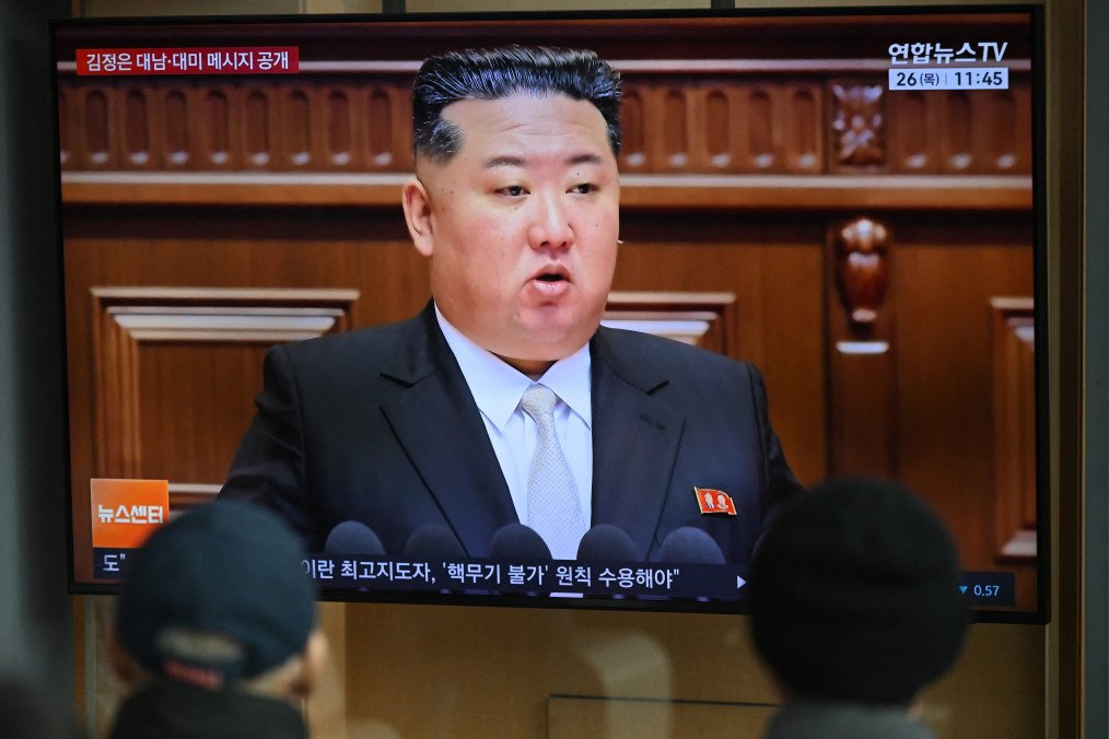 People watch a television screen showing a news broadcast with a photo of North Korea's leader Kim Jong Un attending the 9th Congress of the Workers' Party of Korea, at a railway station in Seoul on February 26, 2026. (Source: Getty Images)