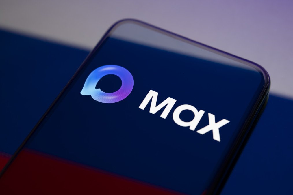 The Max logo appears on a smartphone screen placed on a reflective surface onto which the Russian flag is projected. Illustrative photo. (Source: Getty Images)