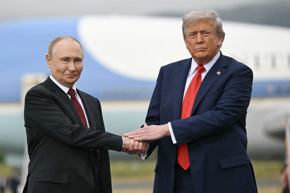 US President Donald Trump greets Russian President Vladimir Putin on the tarmac after they arrived at Joint Base Elmendorf-Richardson in Anchorage, Alaska, on August 15, 2025. (Source: Getty Images)