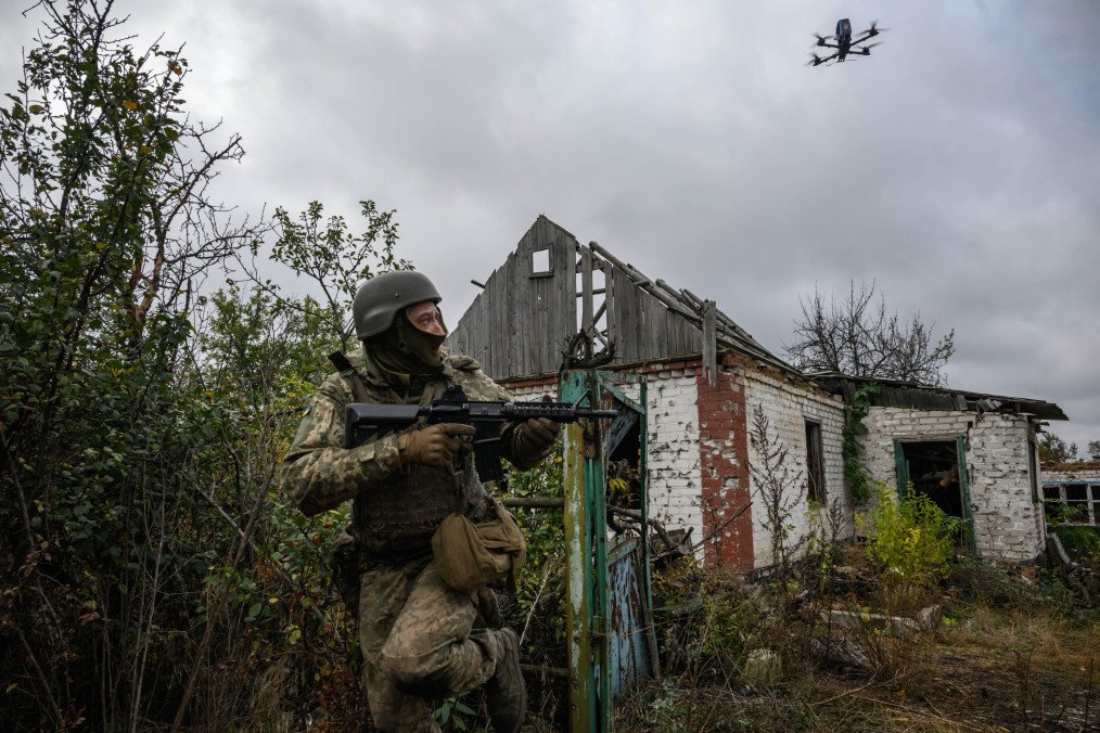 An infantry recruit of the 28th Separate Mechanized Brigade runs from a simulated drone attack during a basic training course at an undisclosed location in eastern Ukraine on October 11, 2025. (Source: Getty Images)