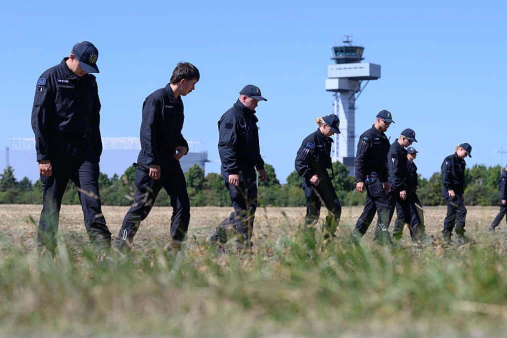 Police officers are searching a field at Leipzig/Halle Airport for evidence, following the drone incident on August 5. (Source: Getty Images) Police officers are searching a field at Leipzig/Halle Airport for evidence, following the drone incident on August 5. (Source: Getty Images)