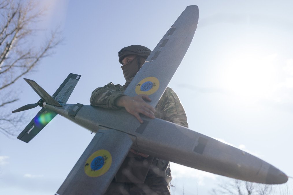 A portrait of a soldier from the "Taifun" unmanned aerial vehicle unit holding a new model “Marsianin” attack drone. (Source: Getty Images)