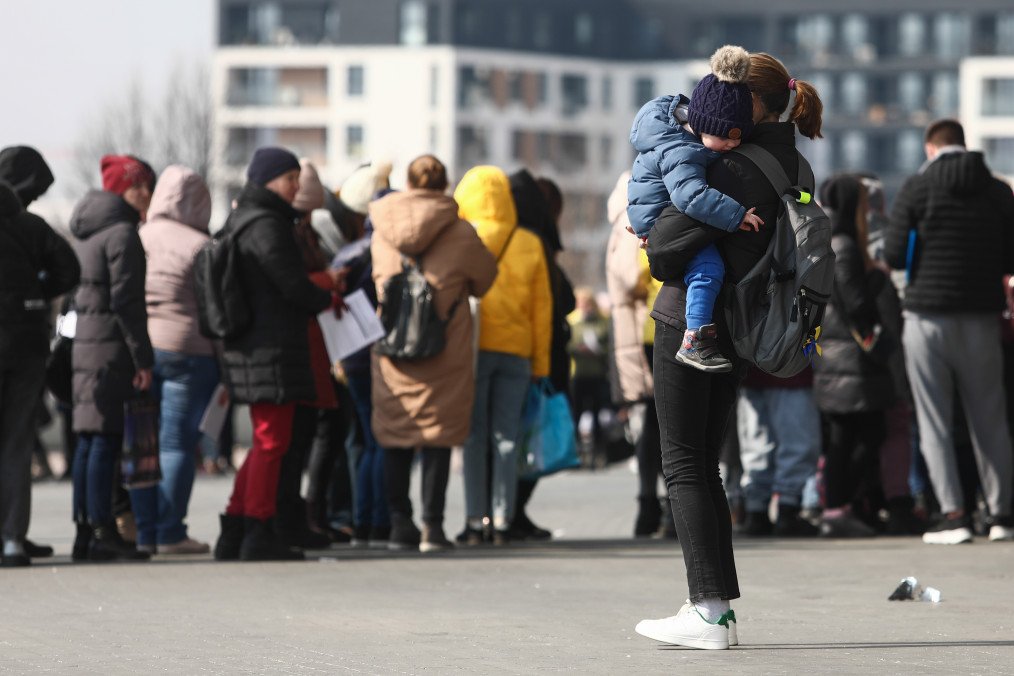 Lithuania Plans €12 Million Allocation to Support Ukrainian Refugees People fleeing from Ukraine wait in a line outside Tauron Arena sports hall where registration point for National Identification Number is opened. (Source: Getty Images)