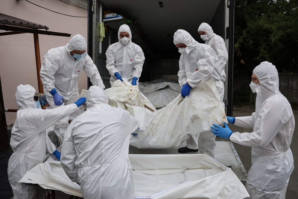 Forensic scientists unloaded from a truck onto a stretcher with bodies of fallen Ukrainian soldiers repatriated as part of the 6000 for 6000 exchange on June 26 2025, in Kyiv, Ukraine. (Source: Getty Images)