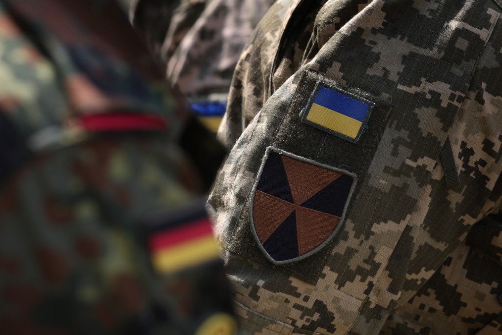 A Ukrainian soldier stands next to a Bundeswehr soldier during NBC countermeasures training at a site training area, Bavaria, Sonthofen, June 29, 2023. (Source: Getty Images)