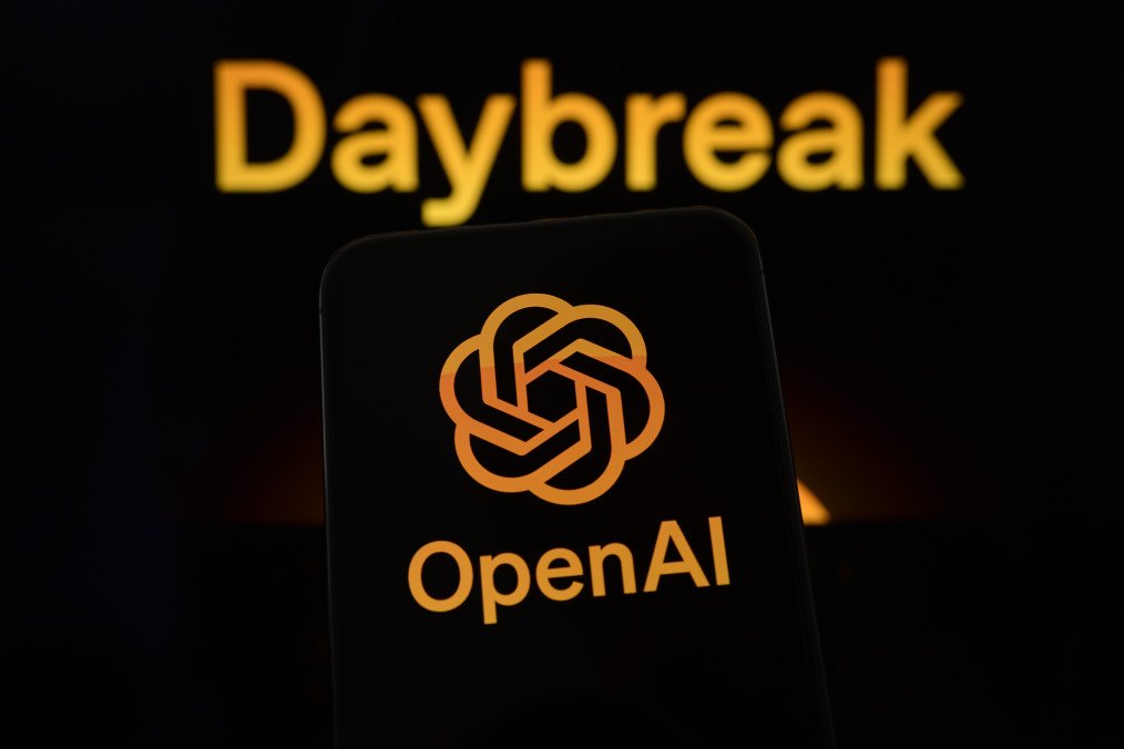 The OpenAI logo is displayed on a smartphone screen, with the Daybreak visual in the background, in Creteil, France, on May 12, 2026. The OpenAI logo is displayed on a smartphone screen, with the Daybreak visual in the background, in Creteil, France, on May 12, 2026.
