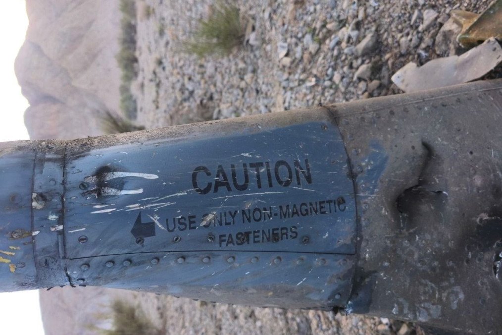 Fragment of aircraft wreckage bearing the warning “CAUTION—USE ONLY NON-MAGNETIC FASTENERS,” reportedly found at the crash site in Iran. (Photo: Open source)