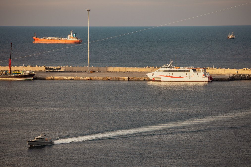 A police speed boat patrols the port as oil tankers and high speed crafts sit anchored at Muscat Anchorage near the Strait of Hormuz. (Source: Getty Images)