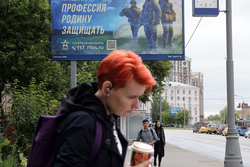 People walk past a billboard advertising contract service in the army, reading "Our profession is to defend the Fatherland," on July 11, 2023, in Moscow, Russia. Illustrative photo. (Source: Getty Images) People walk past a billboard advertising contract service in the army, reading "Our profession is to defend the Fatherland," on July 11, 2023, in Moscow, Russia. Illustrative photo.