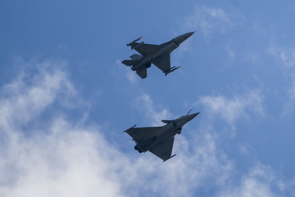 A Dassault Rafale C and an F-16 Fighting Falcon combat airplane perform maneuvers over Ramstein Air Base during a day of fighter plane exercises. (Source: Getty Images)