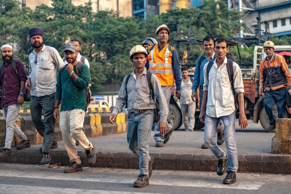 Workers pass by Tata Steel Ltd. plant in Jamshedpur, highlighting daily operations at one of the company's key production sites. (Source: Getty Images)