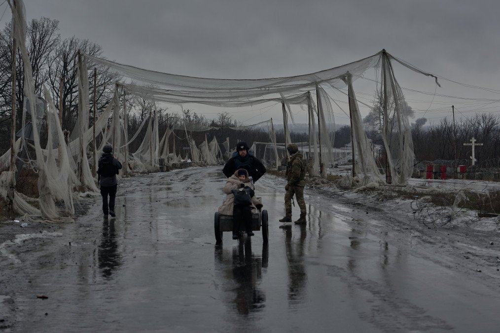 Civilians evacuate Kostyantynivka beneath protective anti-drone nets in Ukraine’s Donetsk region on February 13, 2026. (Source: Getty Images)