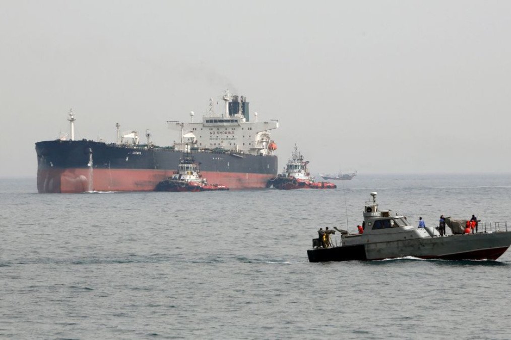 An Iranian military speedboat patrols the waters as a tanker perpares to dock at the oil facility in the Khark Island, on the shore of the Gulf. (Source: Getty Images)