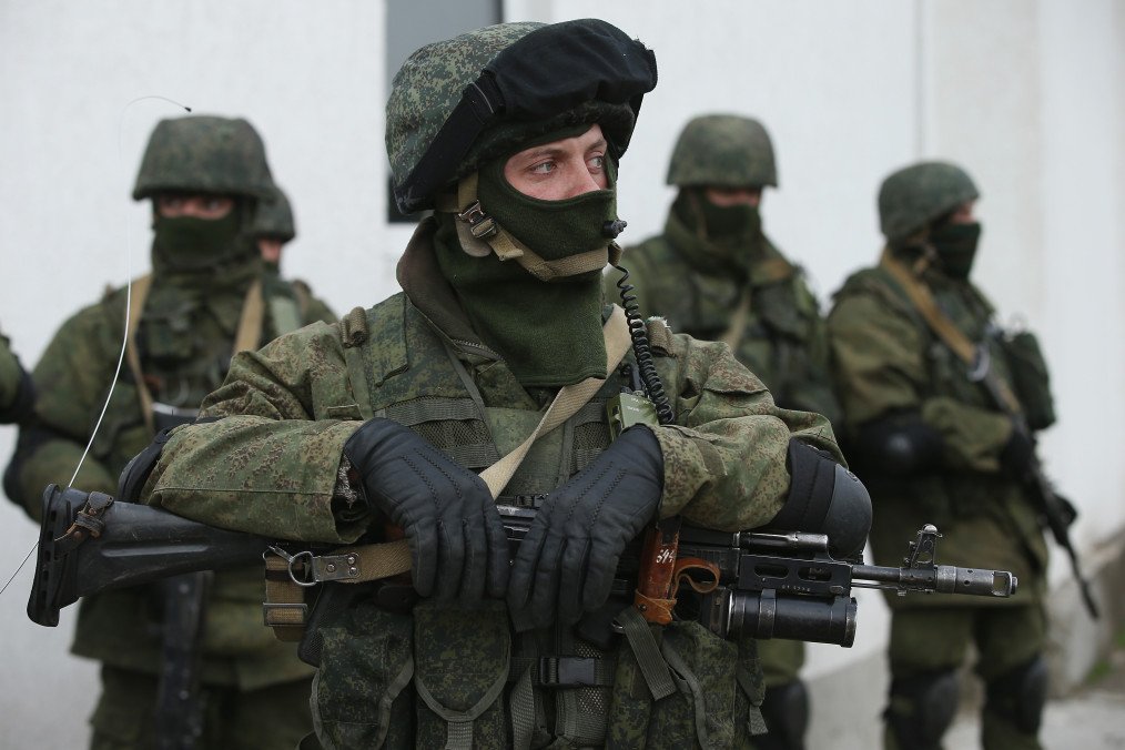 Soldiers who were among several hundred that took up positions around a Ukrainian military base stand near the base's periphery in Crimea on March 2, 2014, in Perevalne, Ukraine. (Source: Getty Images)