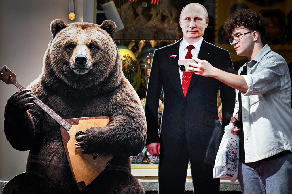 A man takes a selfie with a cardboard cutout of Russian leader Vladimir Putin on the tourist Arbat Street in downtown Moscow on August 24, 2026.