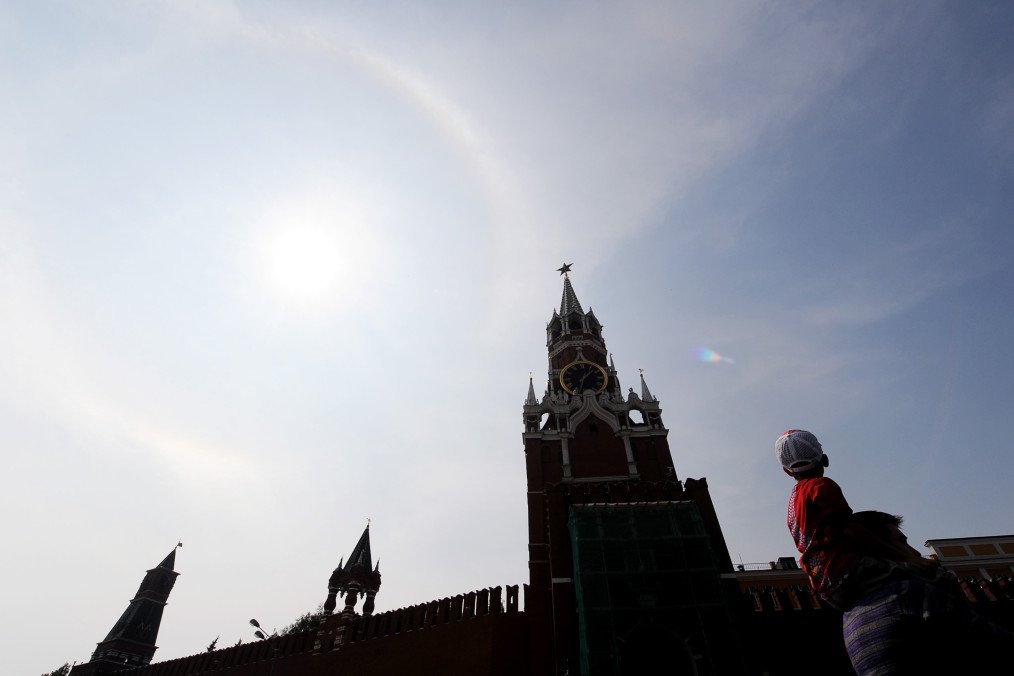 Russians walk near the Kremlin on Red Square under the clear blue skies of Moscow on August 13, 2010. Russians walk near the Kremlin on Red Square under the clear blue skies of Moscow on August 13, 2010.