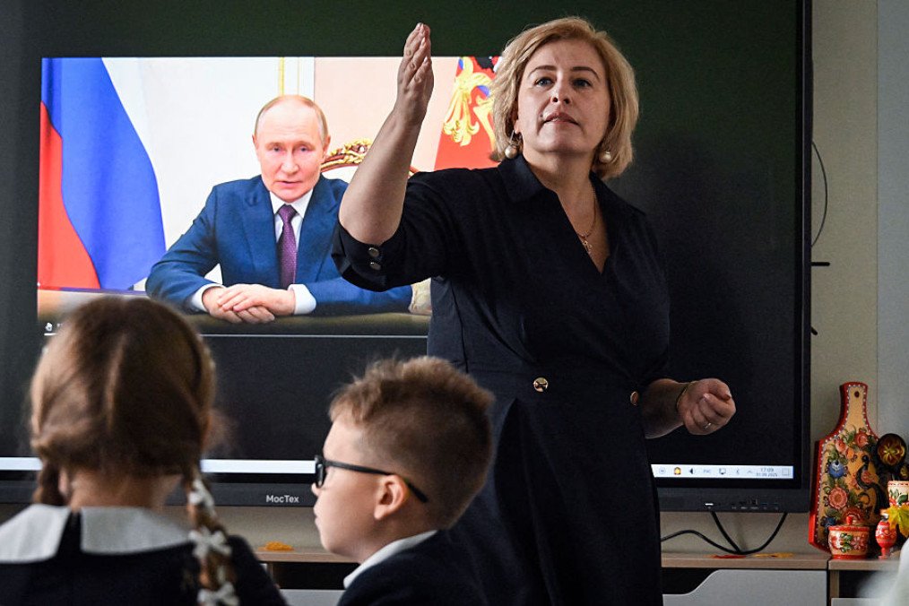 Pupils of a secondary school listen to Russia’s leader Vladimir Putin’s address at the first day of the new school year in Moscow on September 1, 2025. (Source: Getty Images)