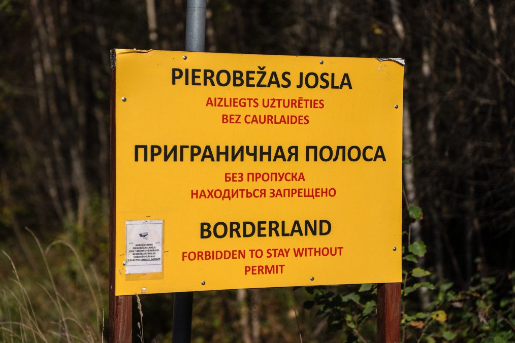 A sign warns people not to proceed along a road near the Latvian border with Russia. (Source: Getty Images)