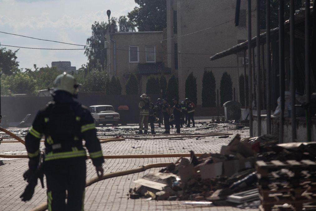 Firefighters and emergency services operate in the parking lot of a company following a Russian drone strike in the city of Sumy, northeastern Ukraine, on June 17, 2026. (Source: Getty Images)