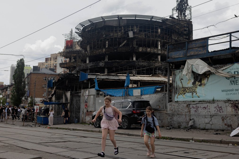 Children are running across the street by a damaged shopping center following Russian strikes in Kyiv on May 25, 2026. (Source: Getty Images)