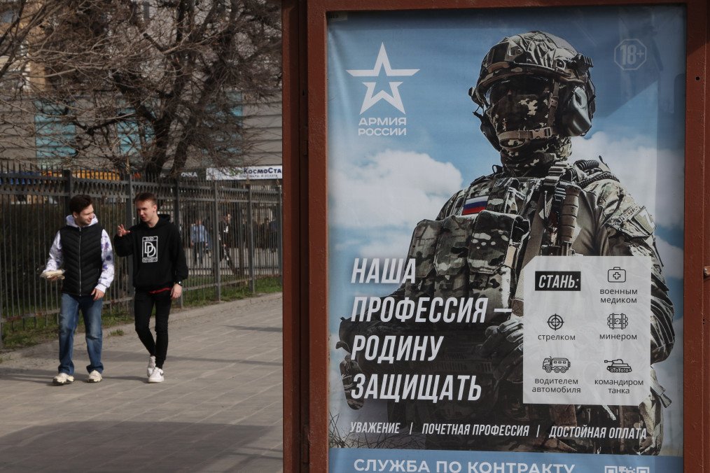 A campaign billboard to sign up for contract service which reads "To defend the Fatherland is our profession" at a bus stop on April 13, 2023 in Moscow, Russia. Illustrative image. (Photo by Contributor/Getty Images)