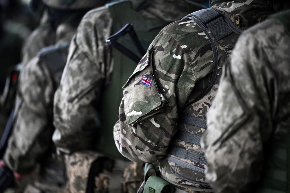 UK Plans to Prepare Nation for Potential War, Armed Forces Minister Says A Union Jack flag is pictured on the sleeve uniform of a soldier during a training excercise operated by Britain's armed forces as part of the Interflex programme for Ukrainian soldiers, in southern England, on August 22, 2024. (Source: Getty Images)