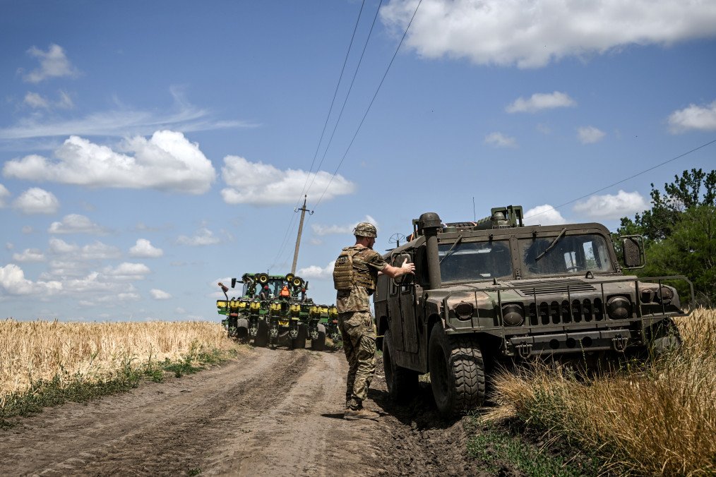 A tractor moves along the road past an HMMWV truck as a soldier heads for a position of a CAESAR self-propelled howitzer crew in Dnipropetrovsk region, Ukraine, on June 23, 2026. (Source: Getty Images) A tractor moves along the road past an HMMWV truck as a soldier heads for a position of a CAESAR self-propelled howitzer crew in Dnipropetrovsk region, Ukraine, on June 23, 2026. (Source: Getty Images)